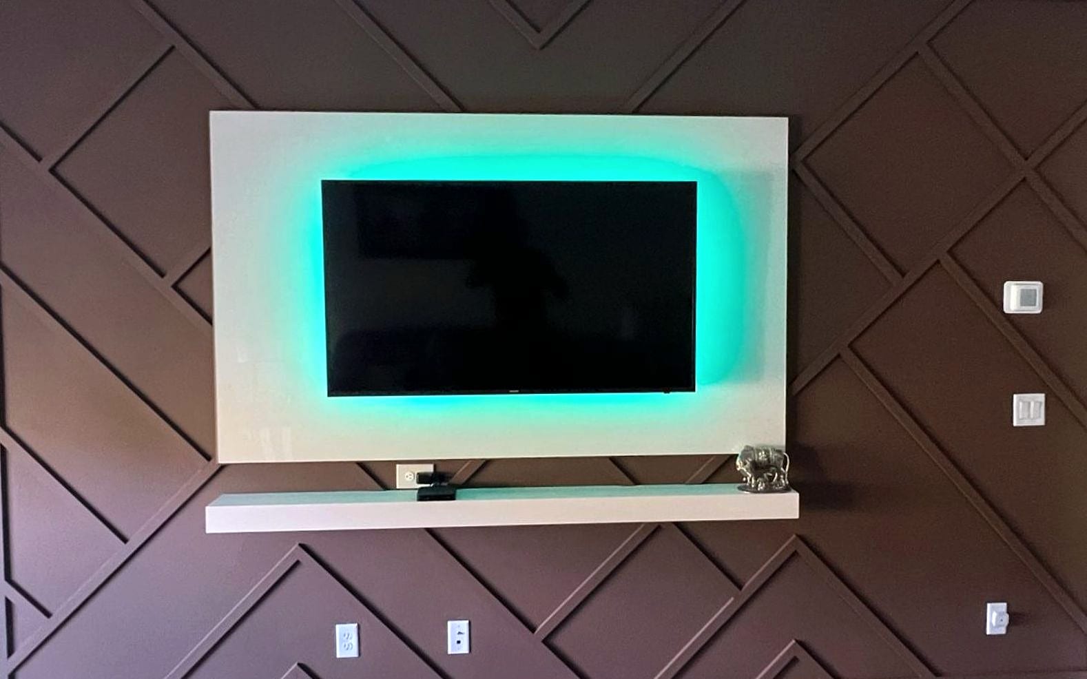 Diagonal panel feature wall with backlit TV