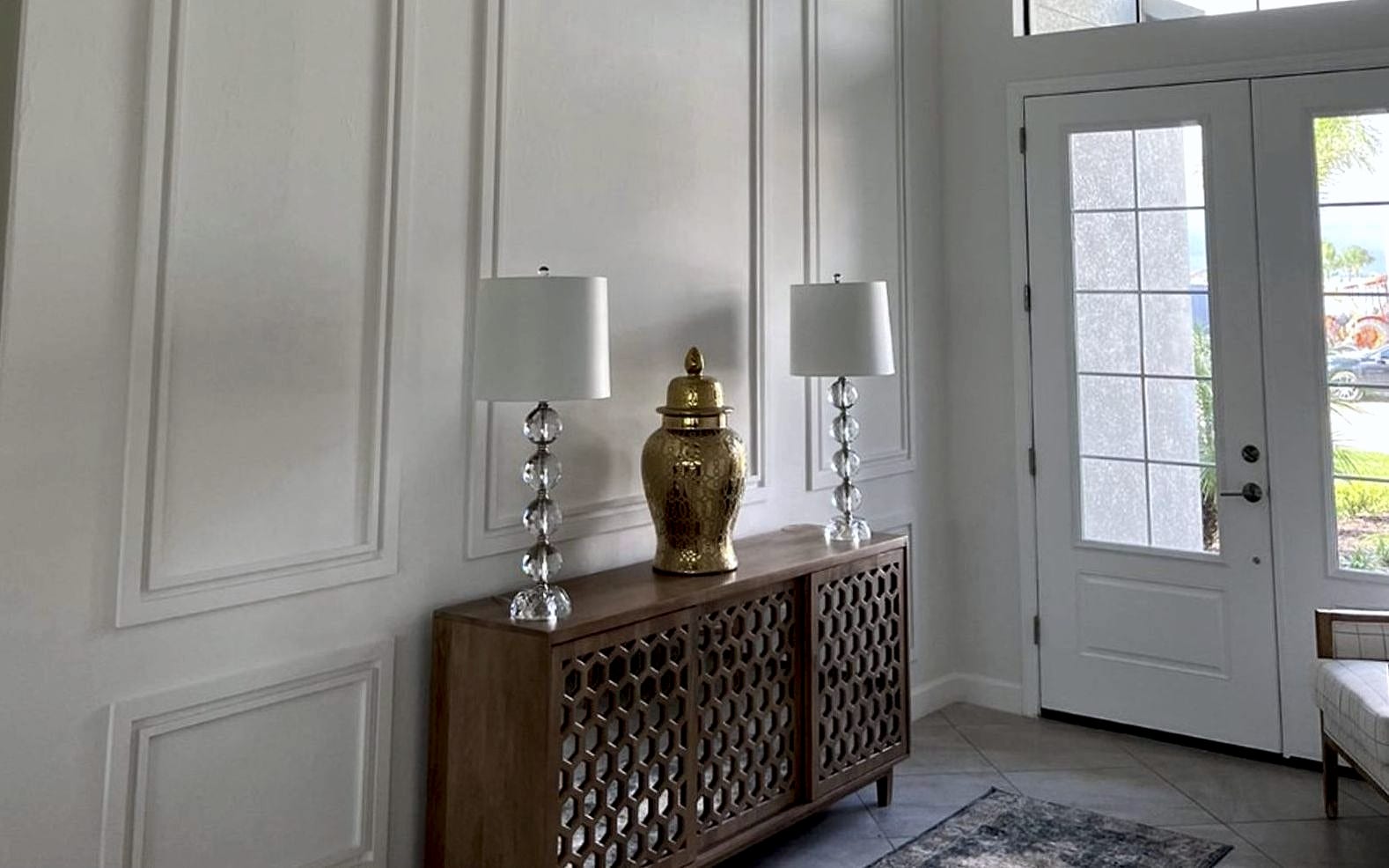 Custom wall paneling and picture-frame molding in a home entry