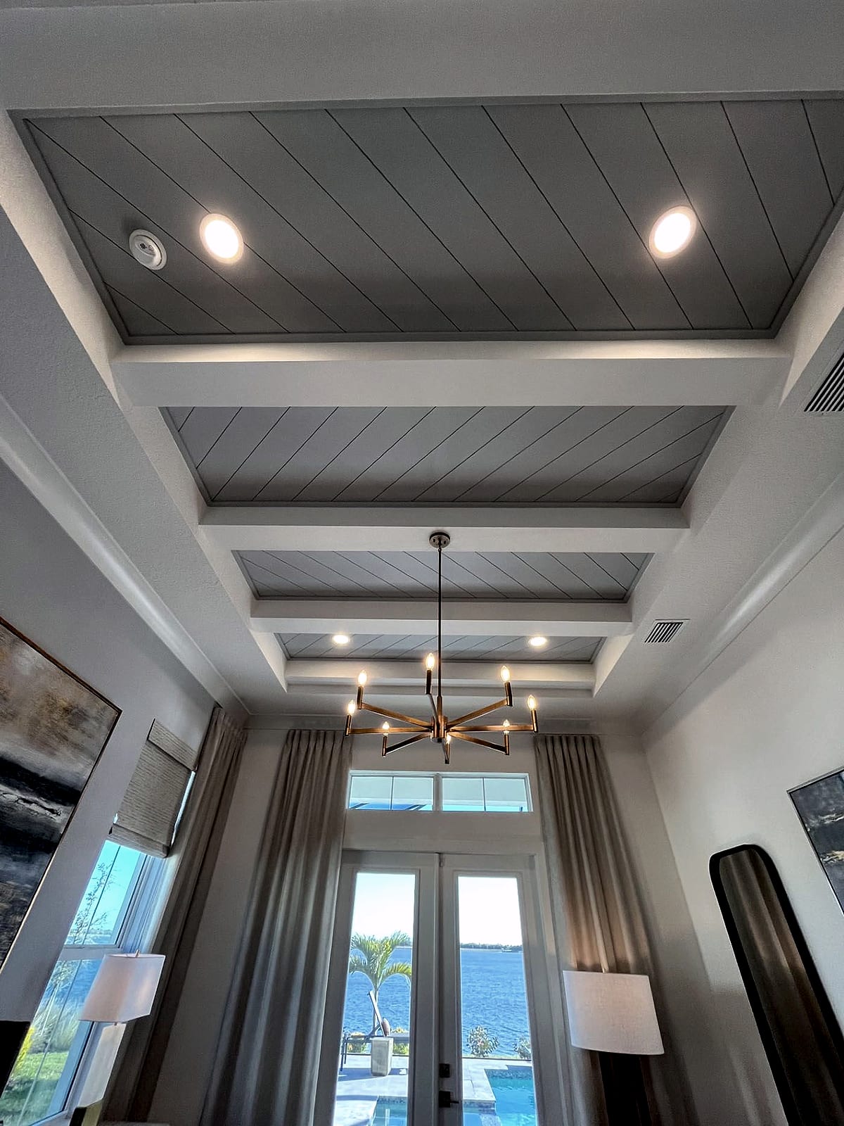 Tongue-and-groove coffered ceiling with beams and recessed lighting